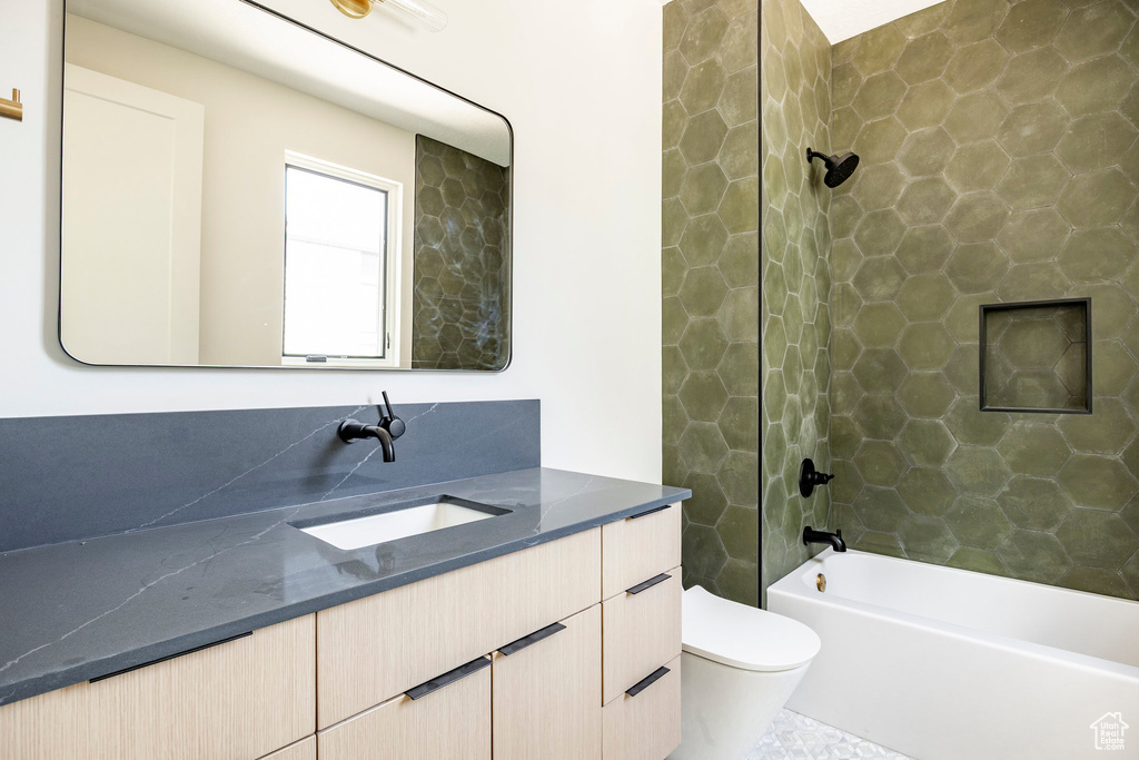 Full bath with vanity, toilet, and tub / shower combination