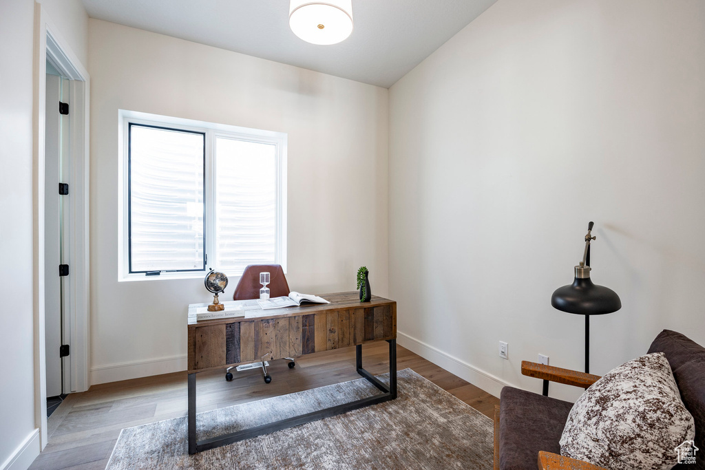 Office space with wood finished floors and baseboards