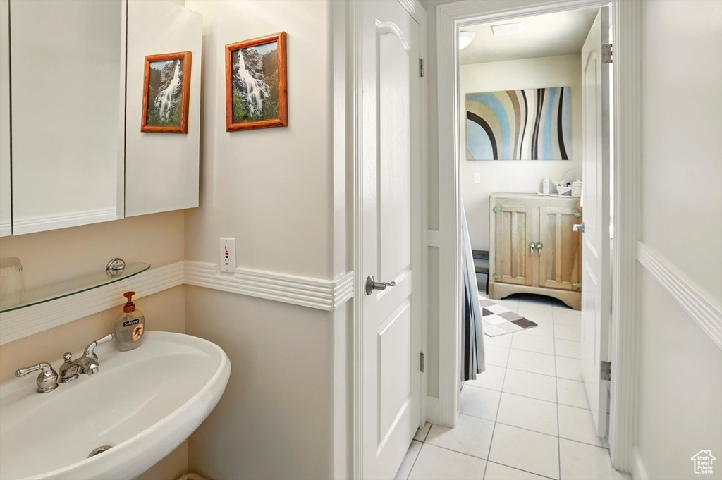 Bathroom with a sink and tile patterned flooring