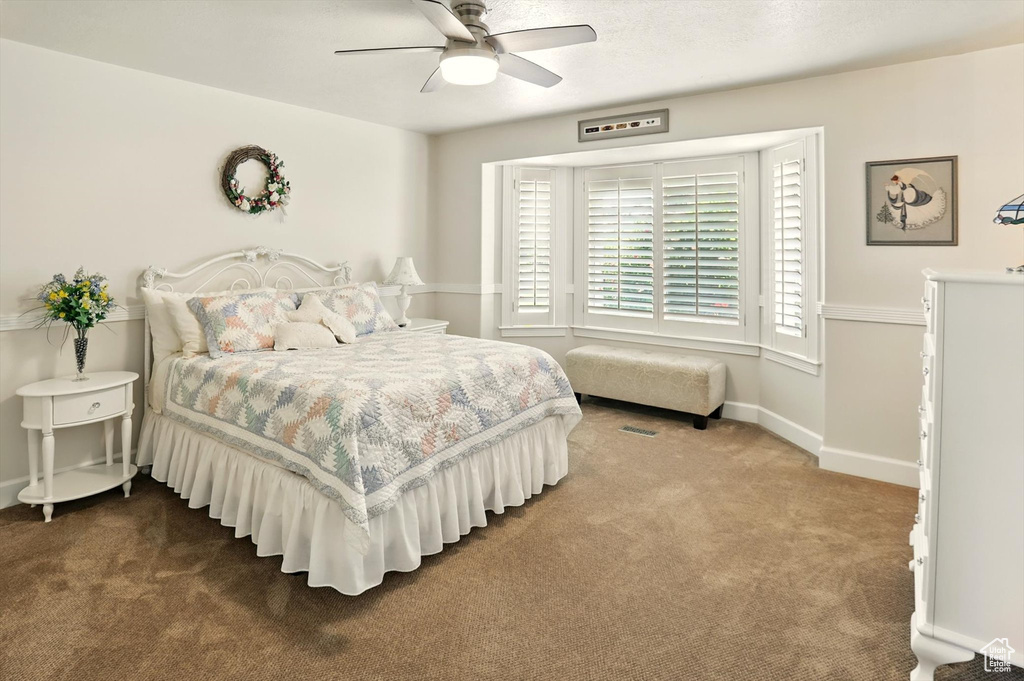 Bedroom featuring carpet flooring, baseboards, and ceiling fan