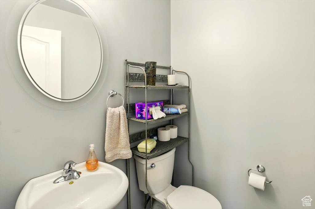 Half bathroom with a sink and toilet