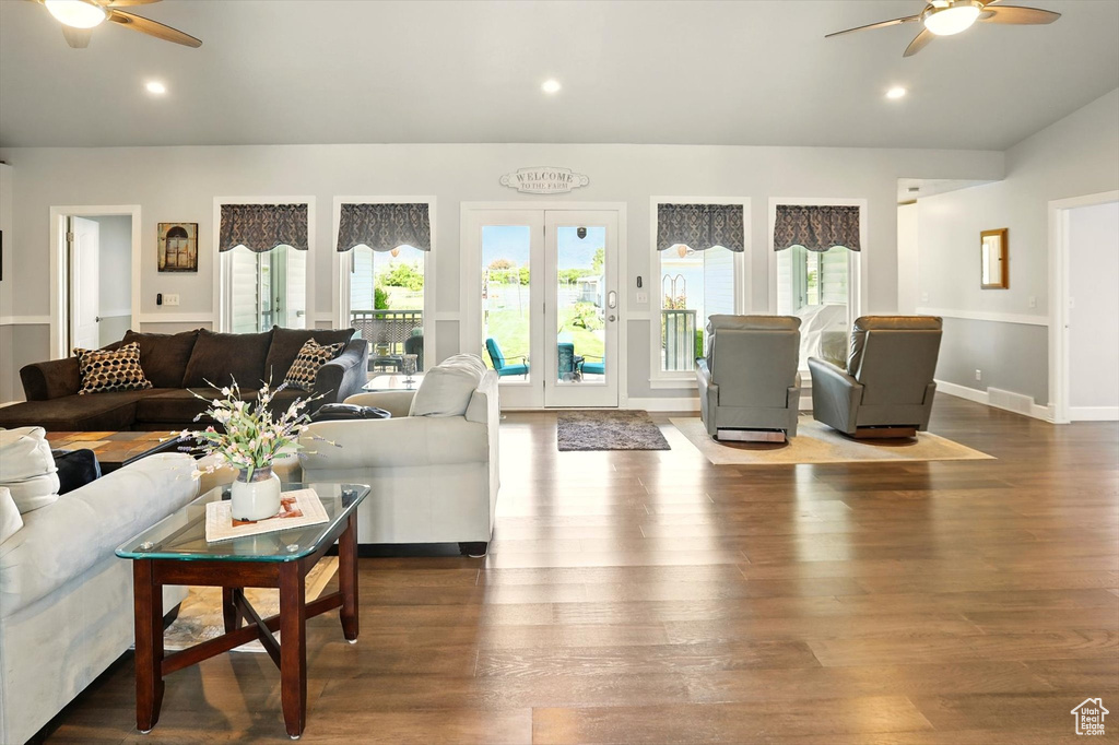 Living room featuring a ceiling fan, wood finished floors, recessed lighting, baseboards, and lofted ceiling