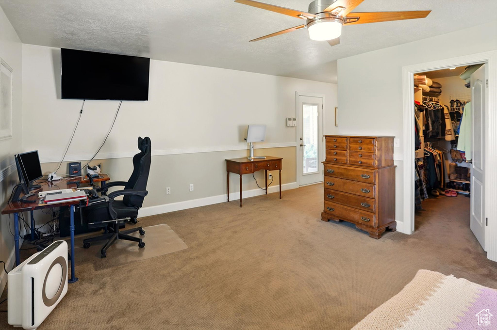 Office area featuring a ceiling fan, carpet, and baseboards