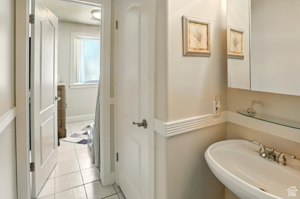 Bathroom featuring a sink and tile patterned floors