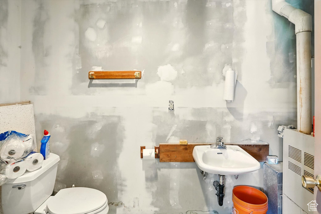 Half bathroom featuring toilet and a sink