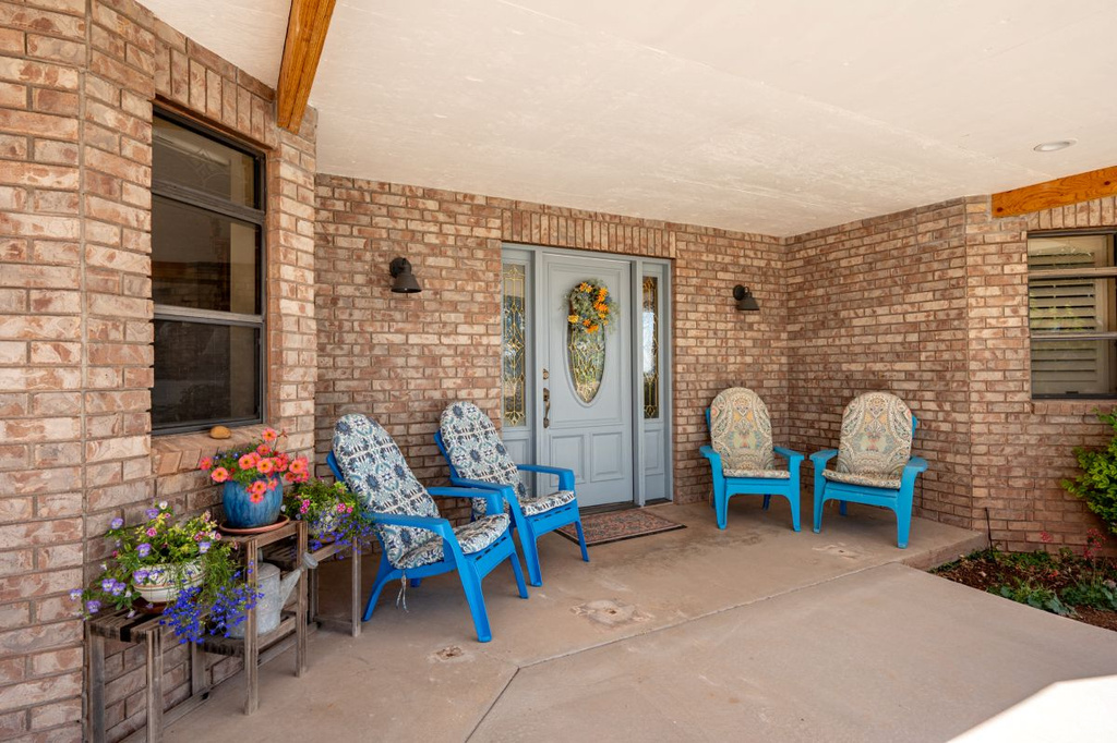 Property entrance with brick siding and covered porch
