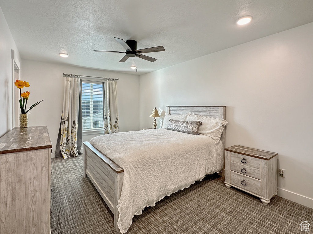 Bedroom with a textured ceiling, dark carpet, baseboards, ceiling fan, and recessed lighting