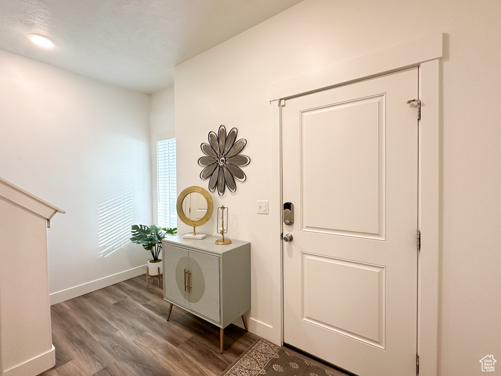 Entrance foyer featuring wood finished floors and baseboards