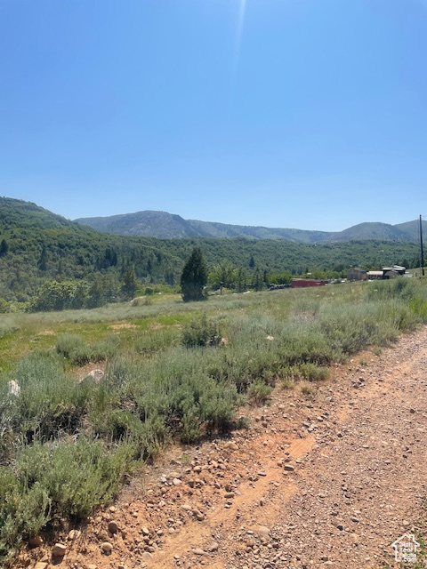 View of mountain background featuring rural landscape