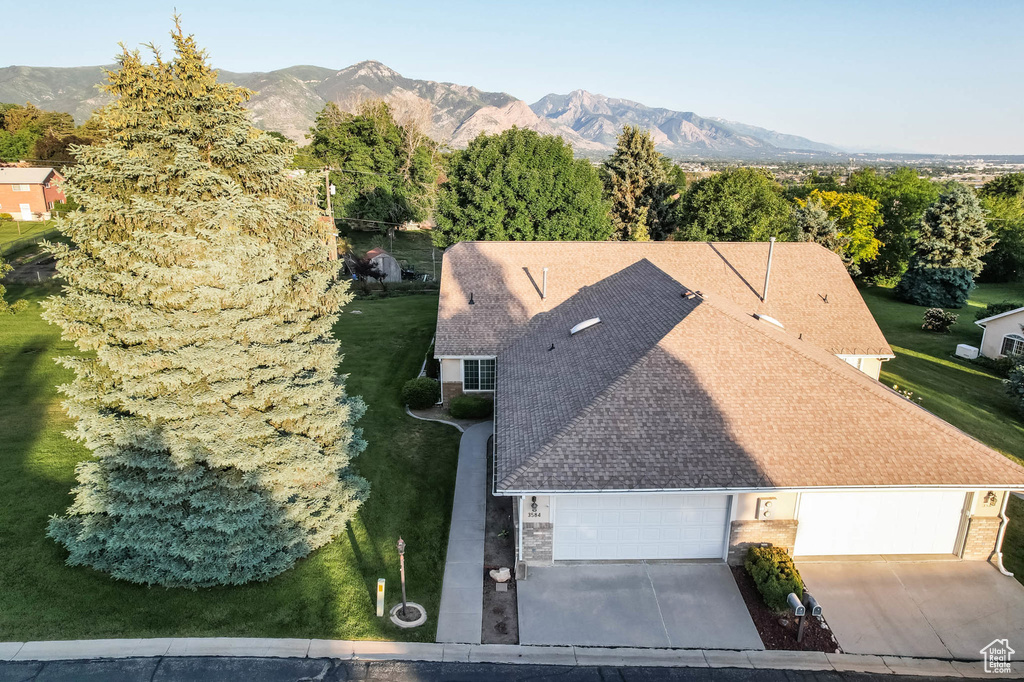 View of subject property with a mountain backdrop