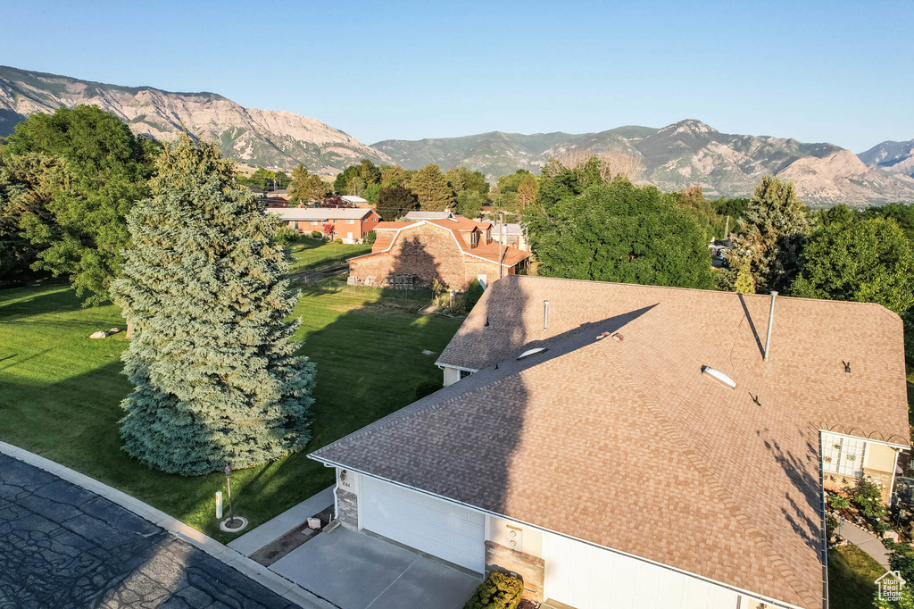 Aerial view of property and surrounding area with a mountain backdrop