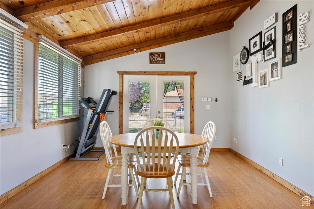 Dining area with light wood-style flooring, wooden ceiling, french doors, and baseboards