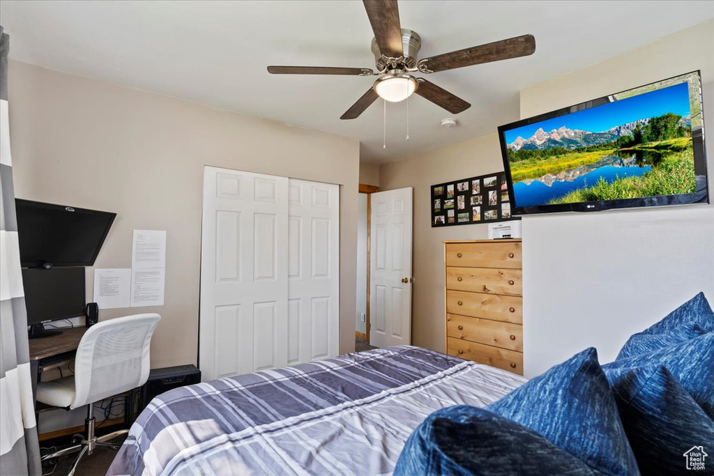 Bedroom featuring an office area, a closet, and a ceiling fan