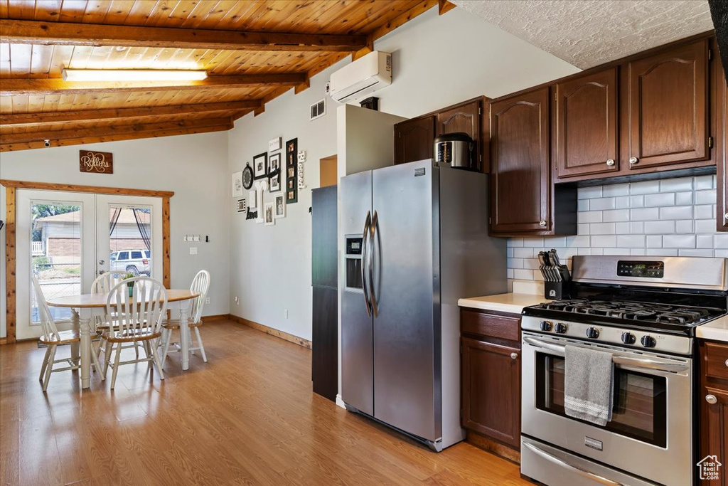 Kitchen featuring appliances with stainless steel finishes, an AC wall unit, wood ceiling, light countertops, and decorative backsplash