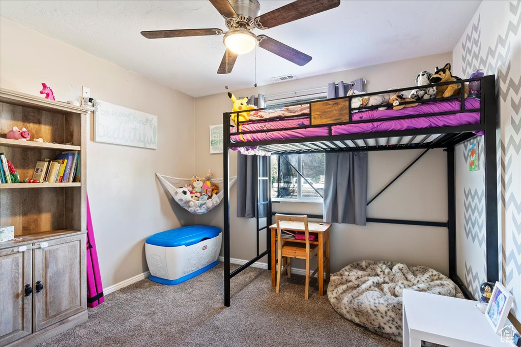 Bedroom featuring carpet floors, baseboards, and a ceiling fan