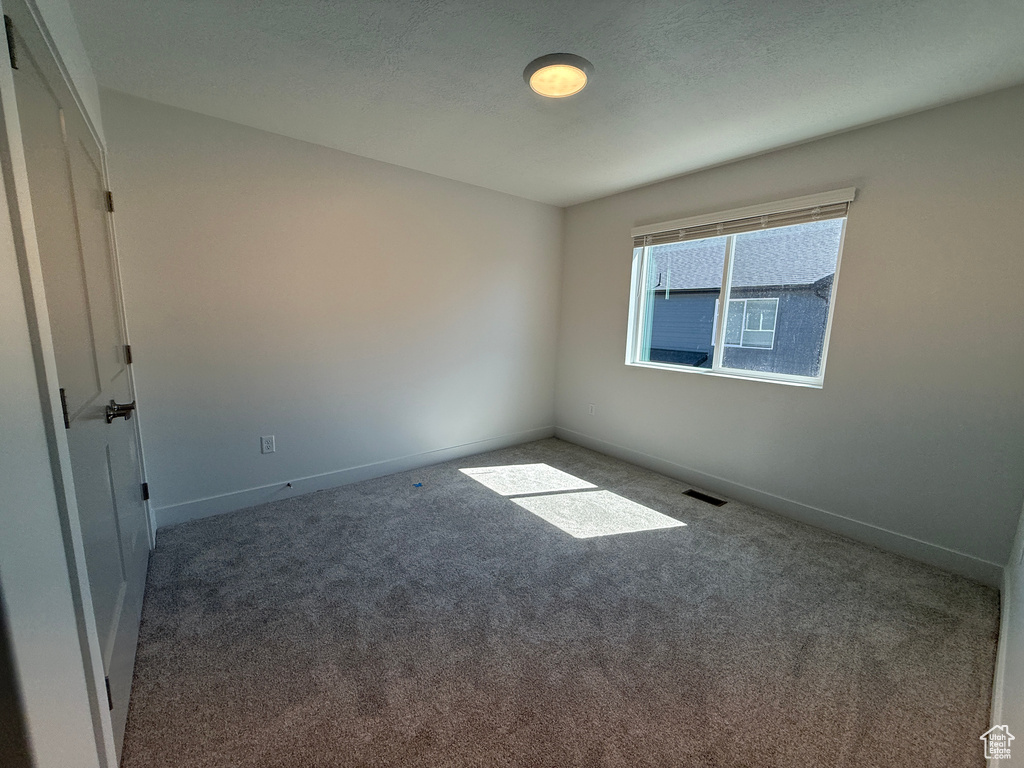 Empty room with carpet floors and baseboards