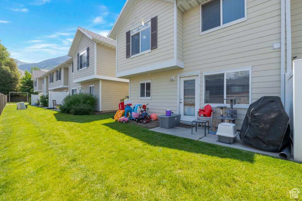 Rear view of property featuring a patio area and a mountain view