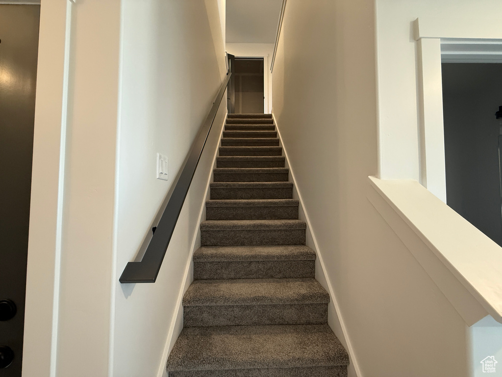 Staircase with baseboards and carpet flooring