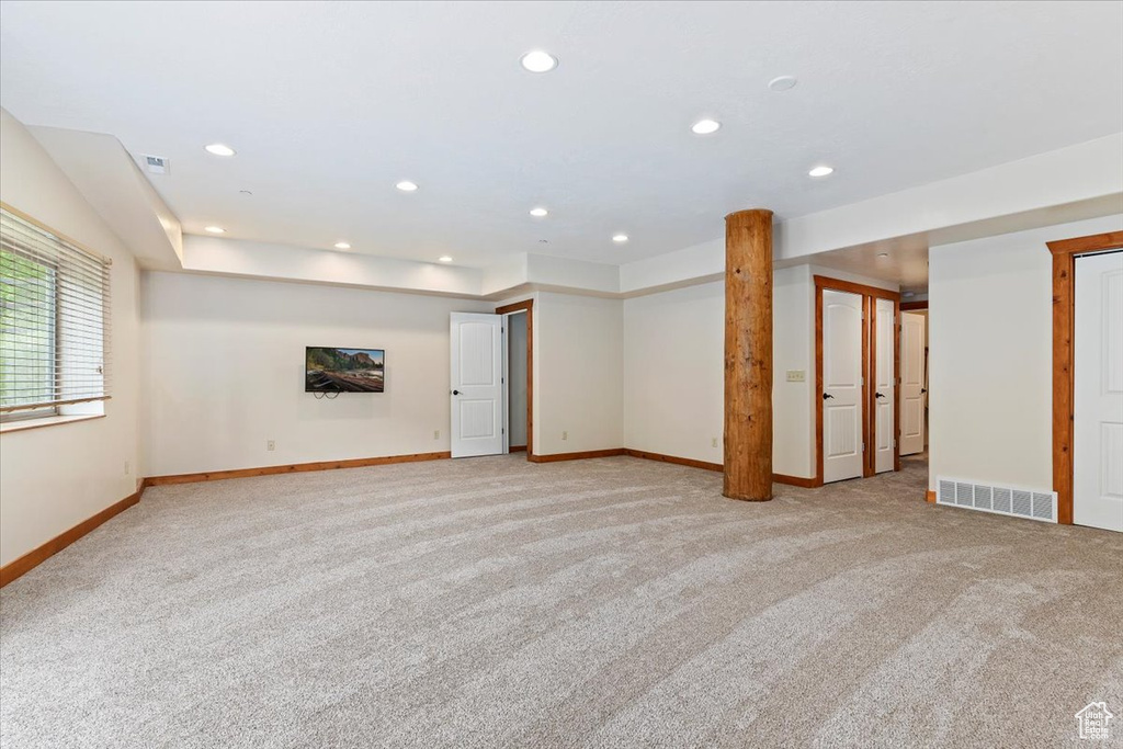 Unfurnished room with light colored carpet, baseboards, and recessed lighting