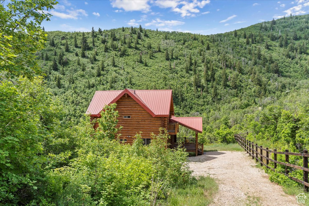 Aerial view of property and surrounding area with a heavily wooded area