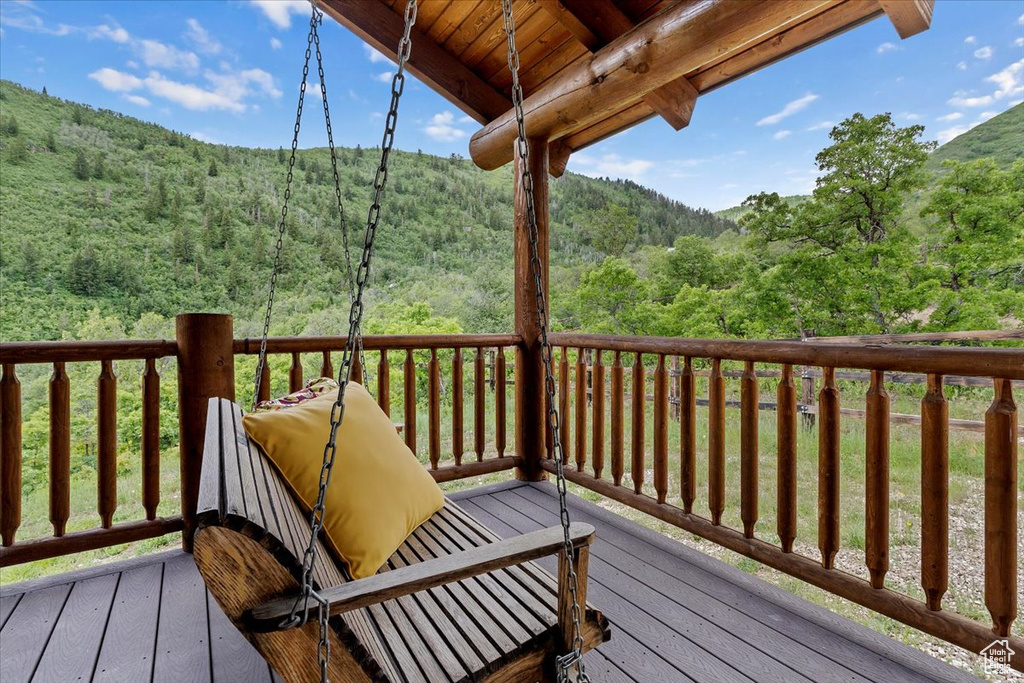 Wooden deck featuring a view of trees and a mountain view