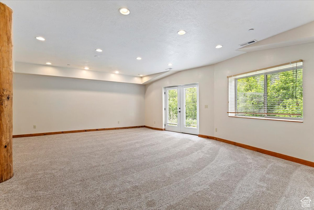 Carpeted spare room with baseboards and recessed lighting