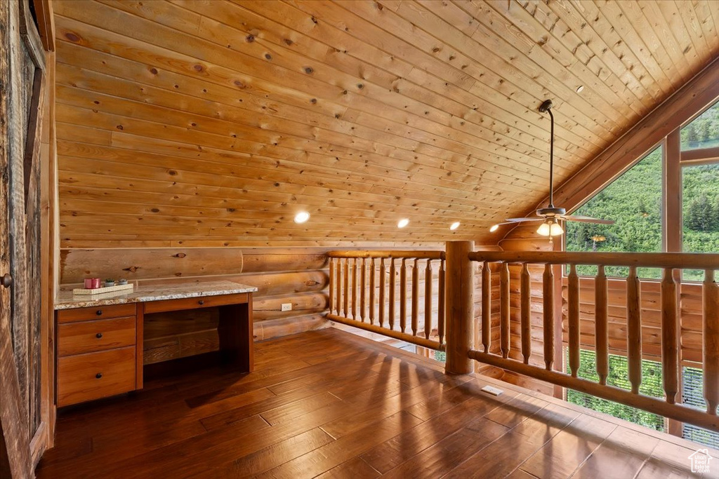 Unfurnished office featuring wood ceiling, dark wood-style floors, a ceiling fan, lofted ceiling, and log walls