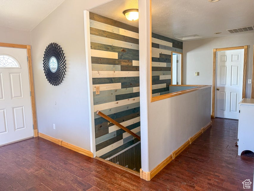 Entrance foyer with wood finished floors and baseboards