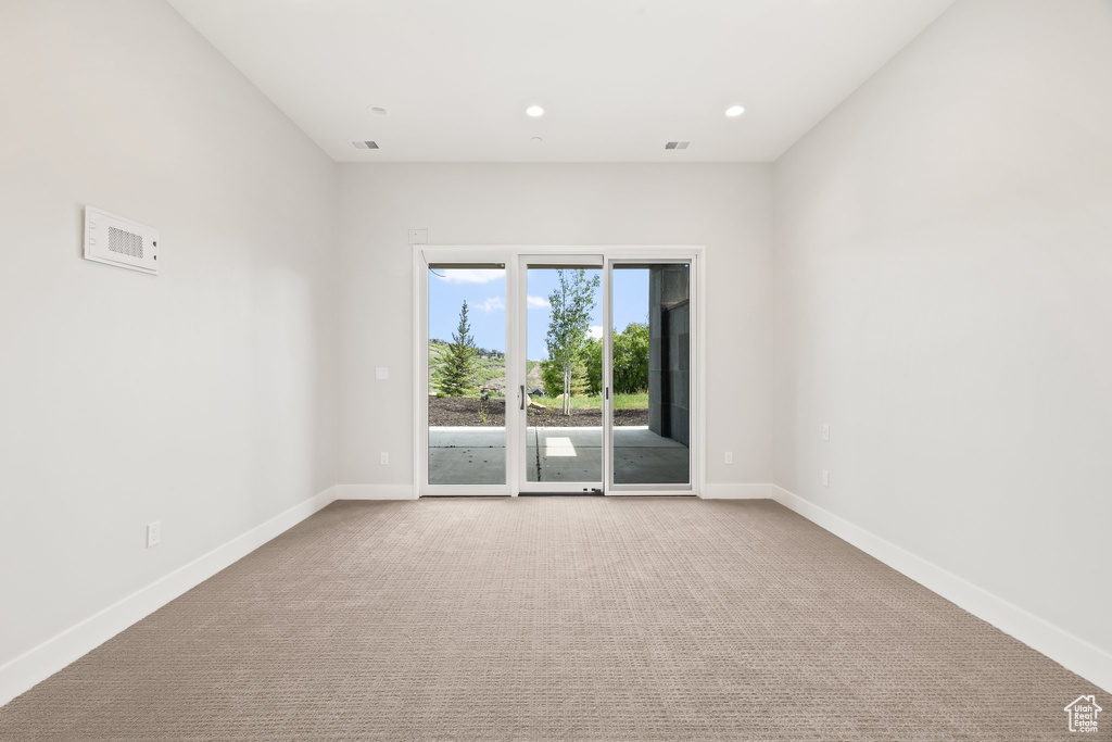 Spare room featuring carpet, baseboards, and recessed lighting