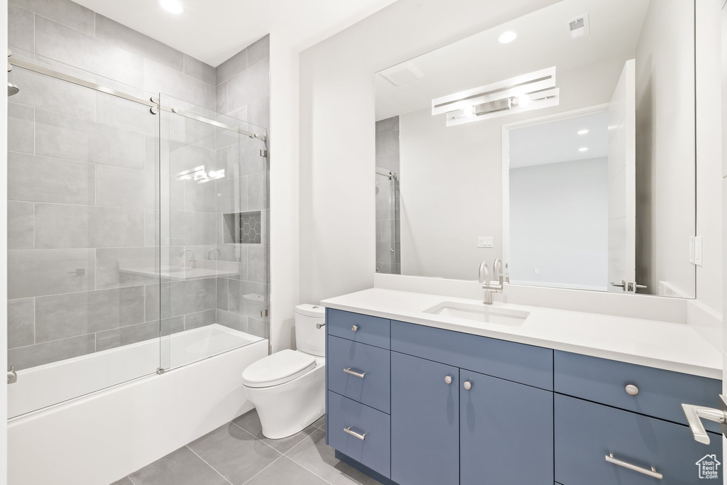 Full bath featuring toilet, vanity, tile patterned flooring, enclosed tub / shower combo, and recessed lighting