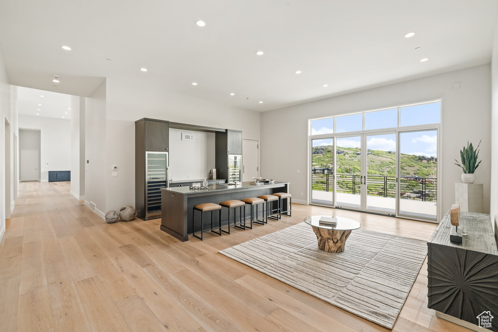 Living area with recessed lighting, light wood-style flooring, and baseboards