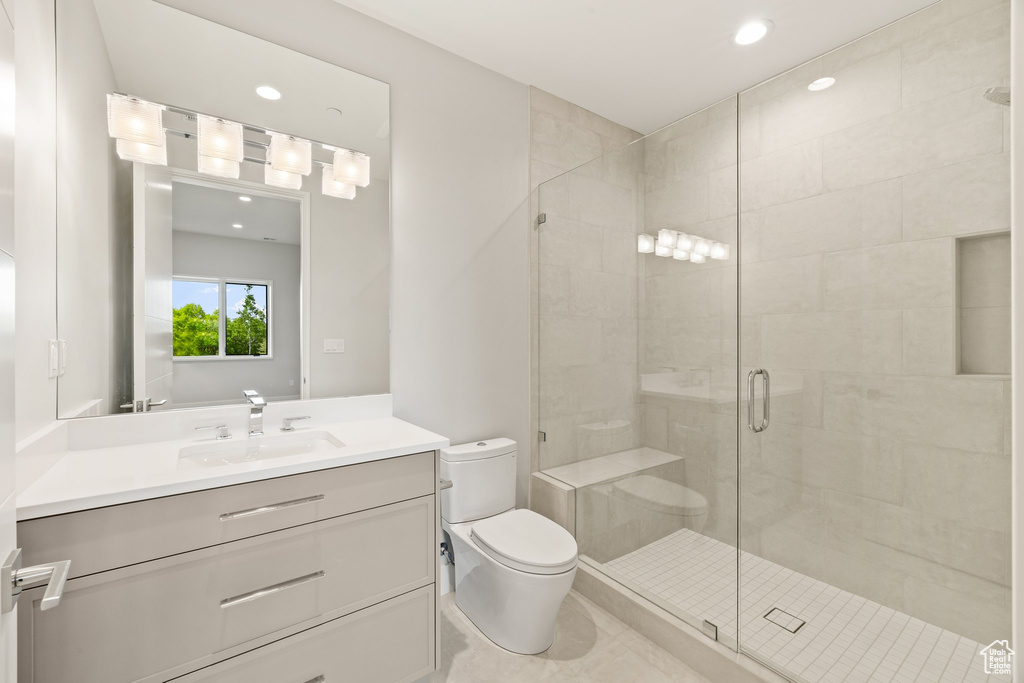 Full bath with toilet, a stall shower, vanity, and recessed lighting