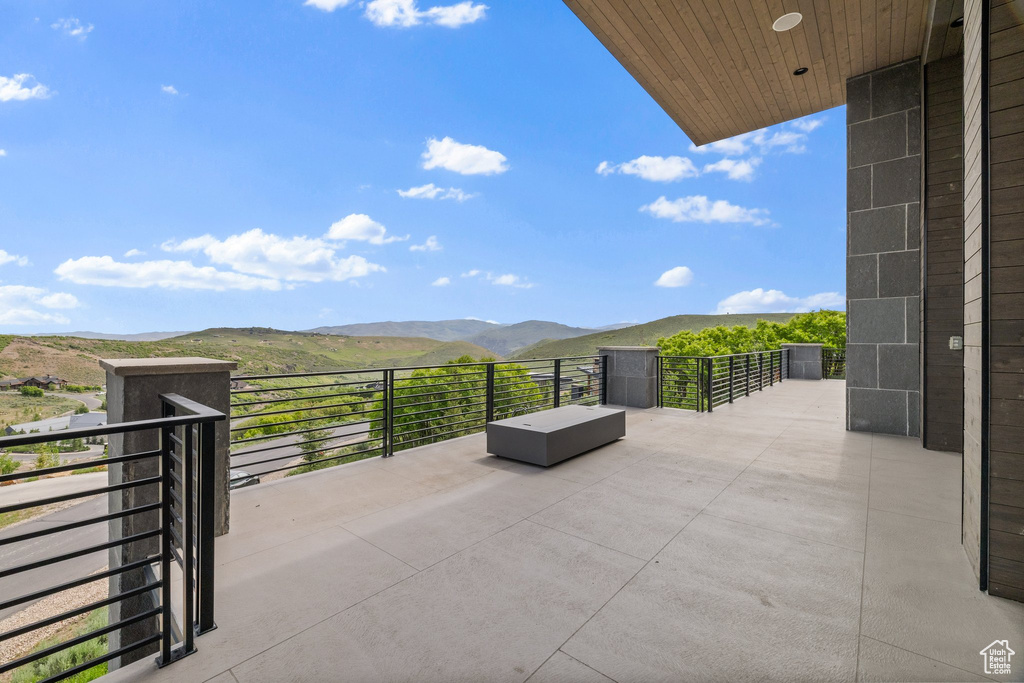 View of patio / terrace with a mountain view and a balcony