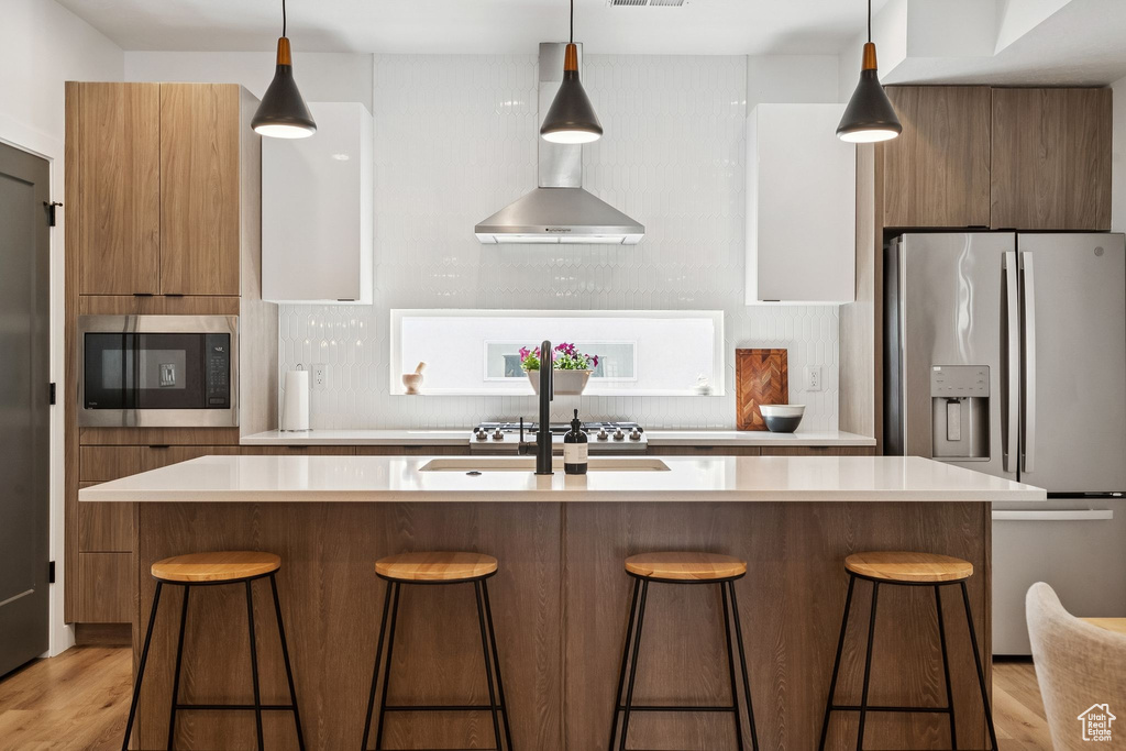Kitchen with appliances with stainless steel finishes, modern cabinets, and light countertops