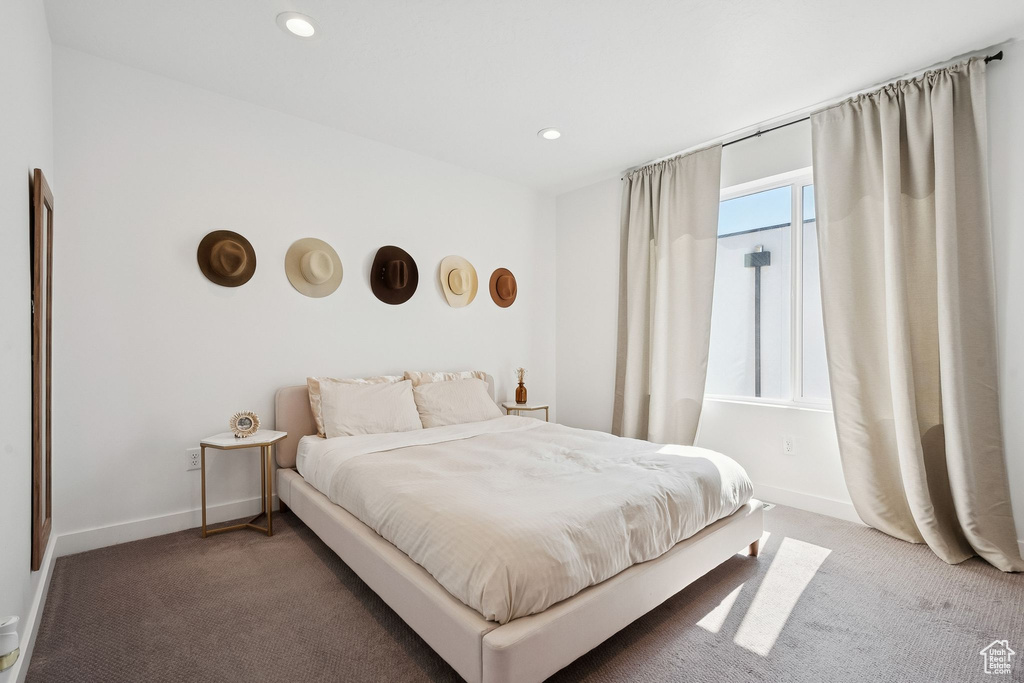 Bedroom with carpet flooring, baseboards, and recessed lighting
