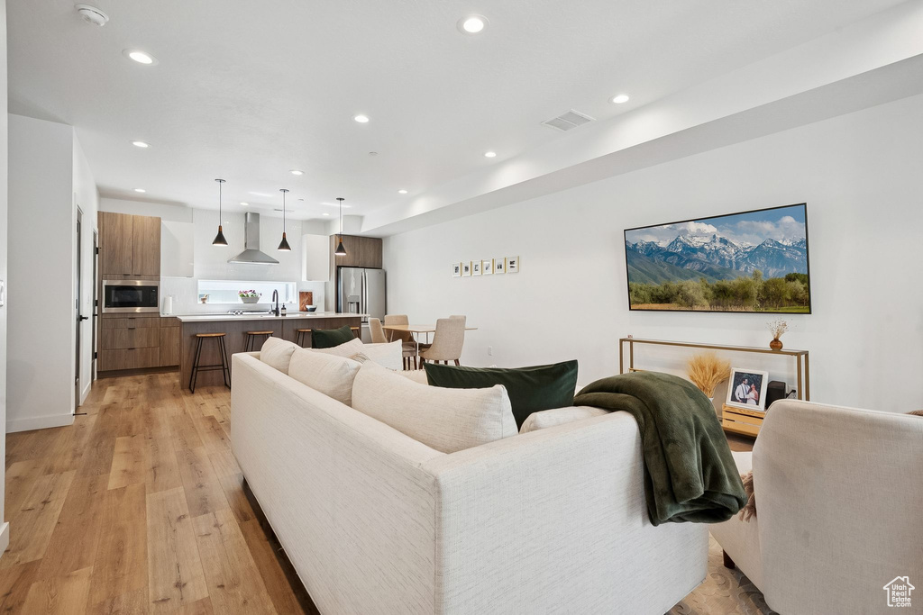 Living room with recessed lighting and light wood-style floors