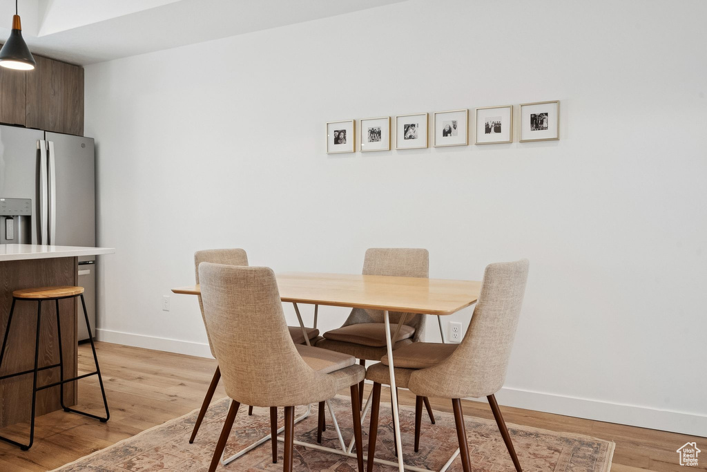 Dining area with baseboards and light wood finished floors