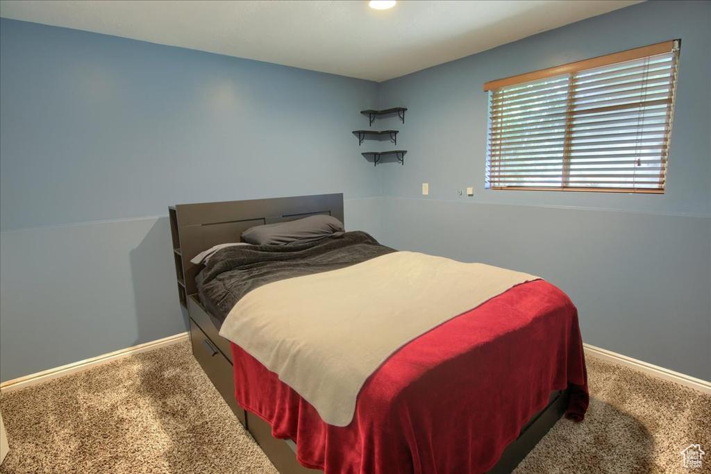 Bedroom featuring carpet flooring and baseboards