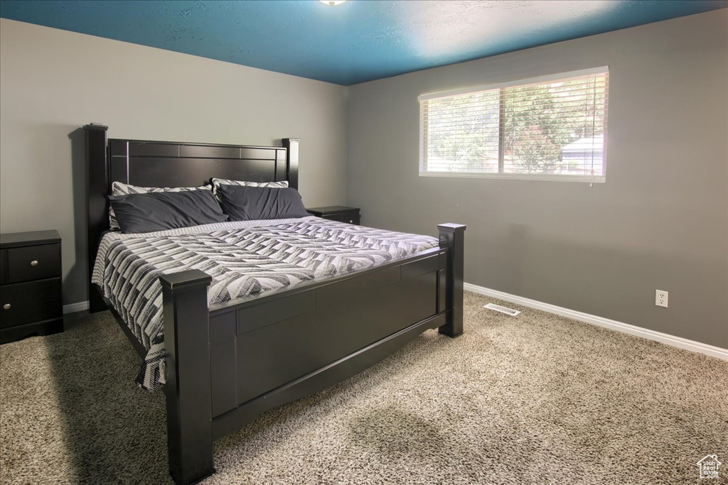 Bedroom featuring carpet floors and baseboards