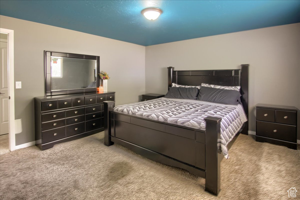 Carpeted bedroom featuring baseboards