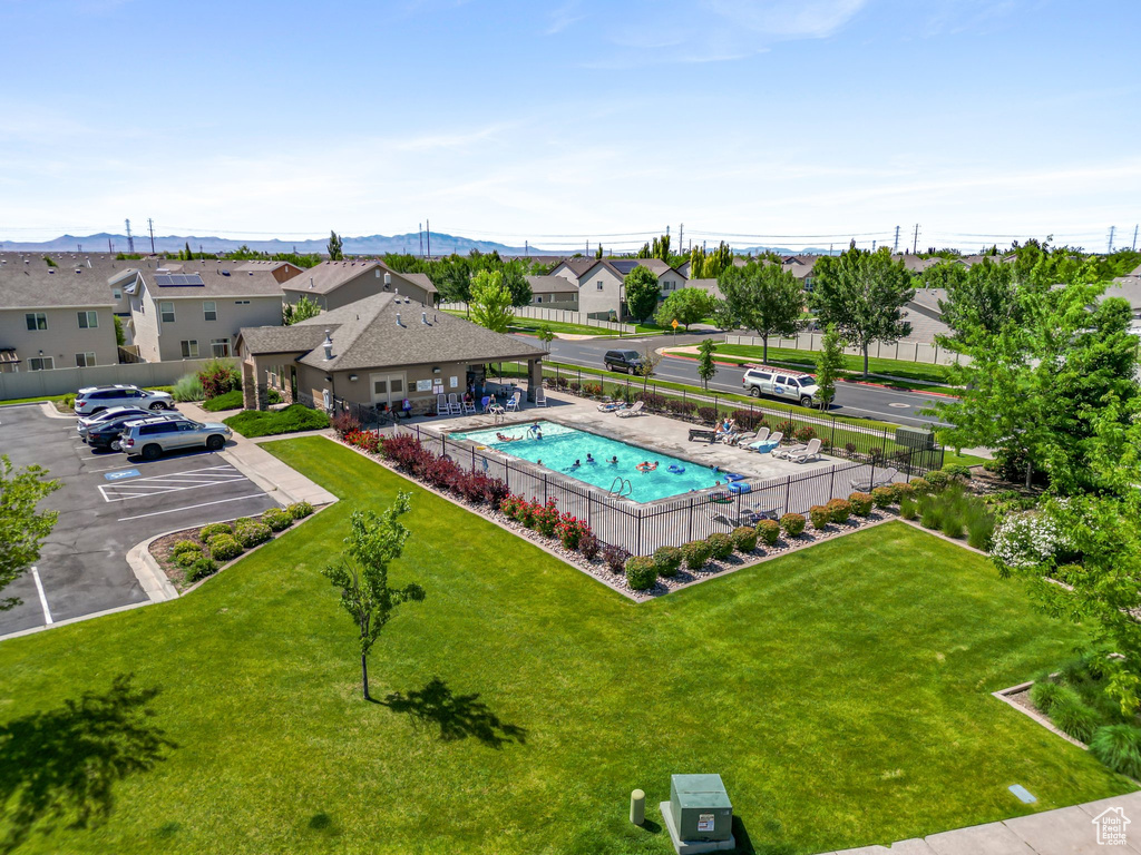 Aerial perspective of suburban area with a pool and a mountainous background