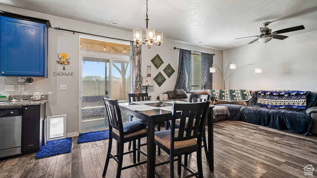 Dining room with dark wood-style flooring, healthy amount of natural light, and ceiling fan