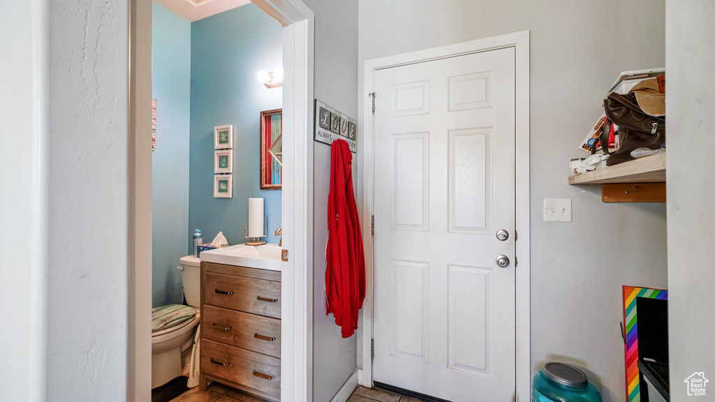 Half bathroom featuring toilet and vanity