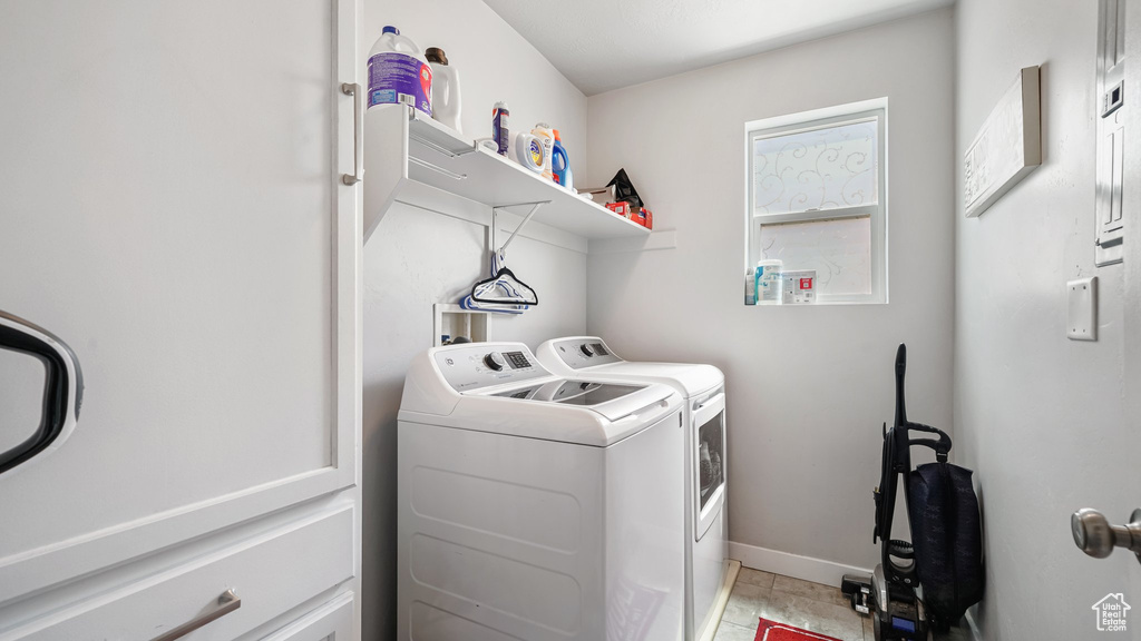 Laundry room featuring washing machine and dryer and baseboards