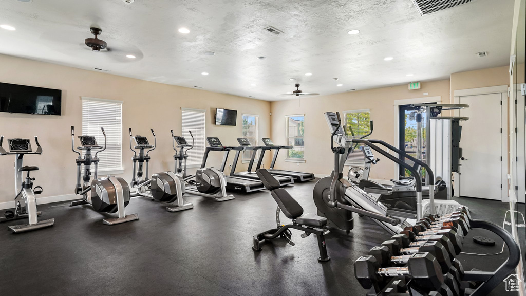 Gym with ceiling fan, recessed lighting, and baseboards