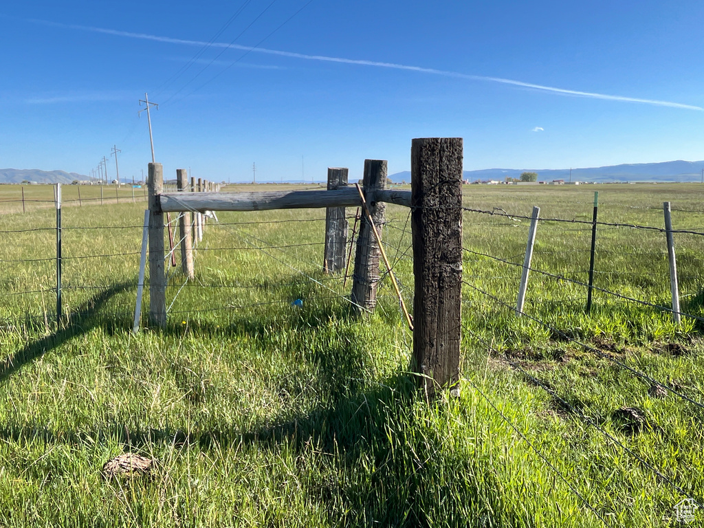 Gate featuring a rural view and a mountain view