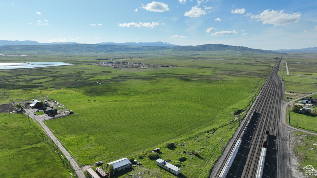 Aerial view of sparsely populated area with mountains and a major roadway