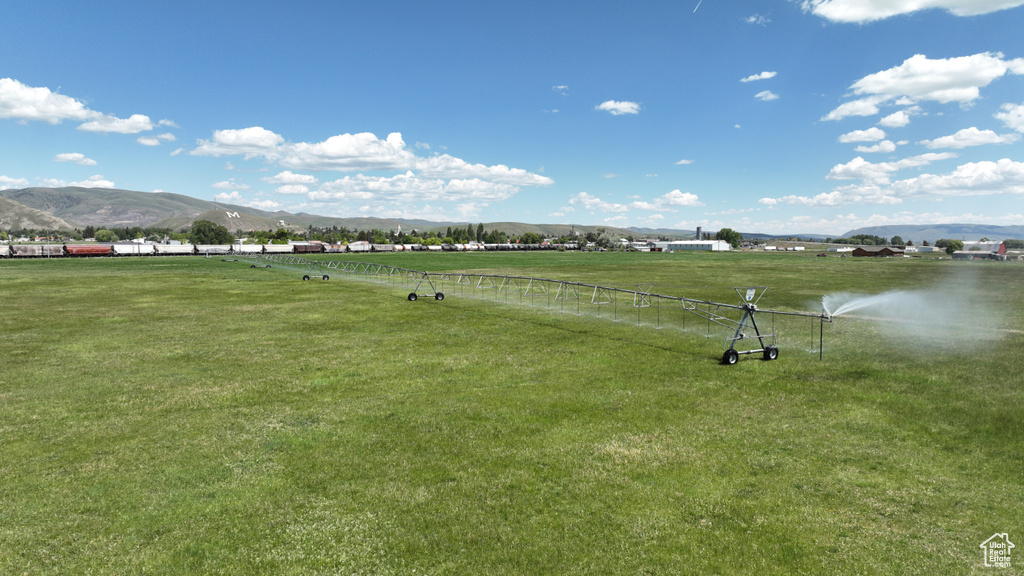 Surrounding community featuring a mountain view and a yard