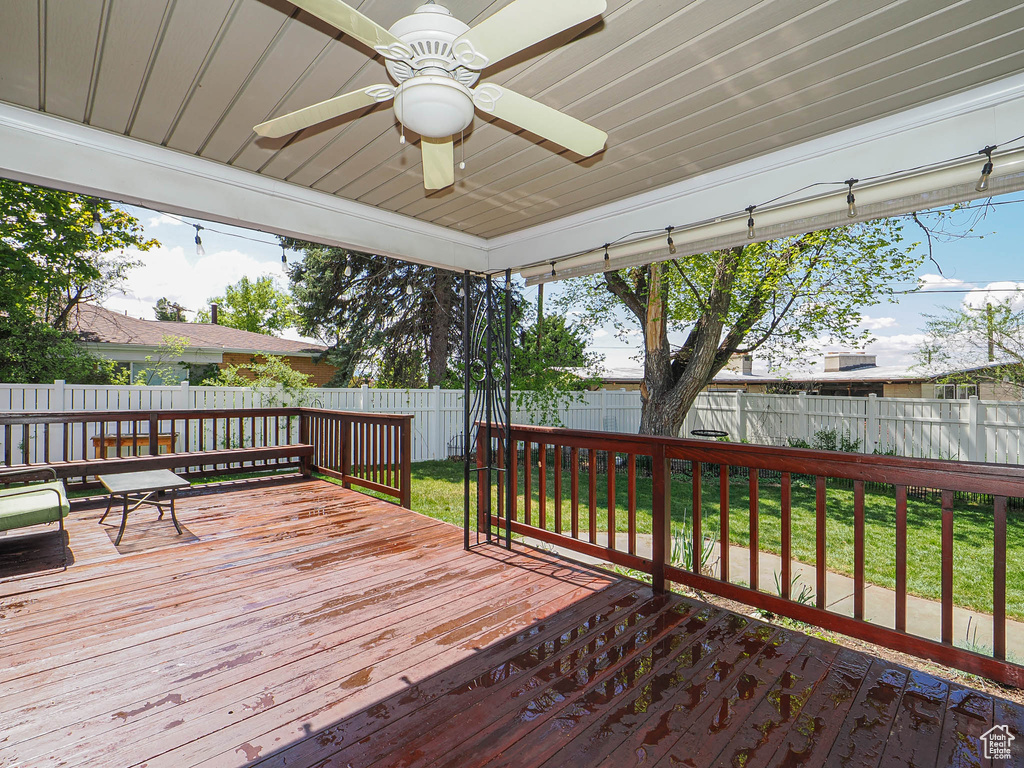 Wooden terrace featuring ceiling fan