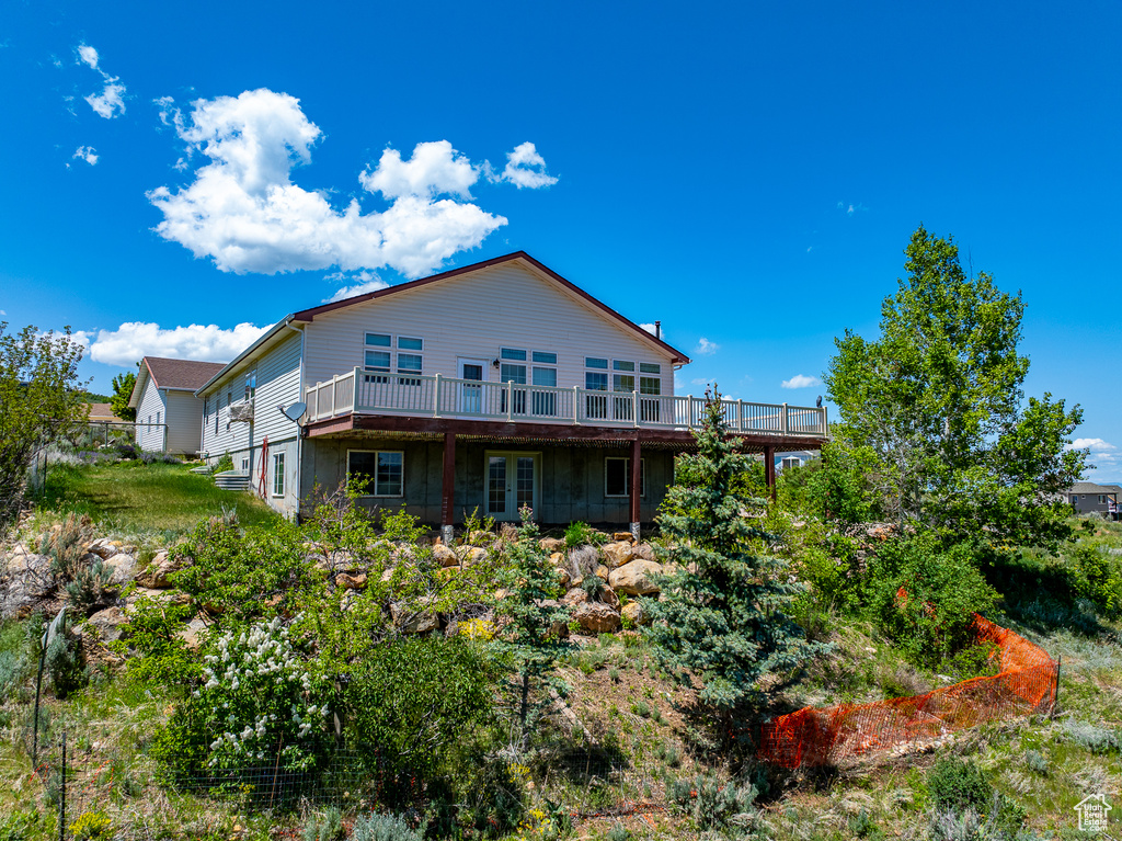 Rear view of property with a deck and french doors